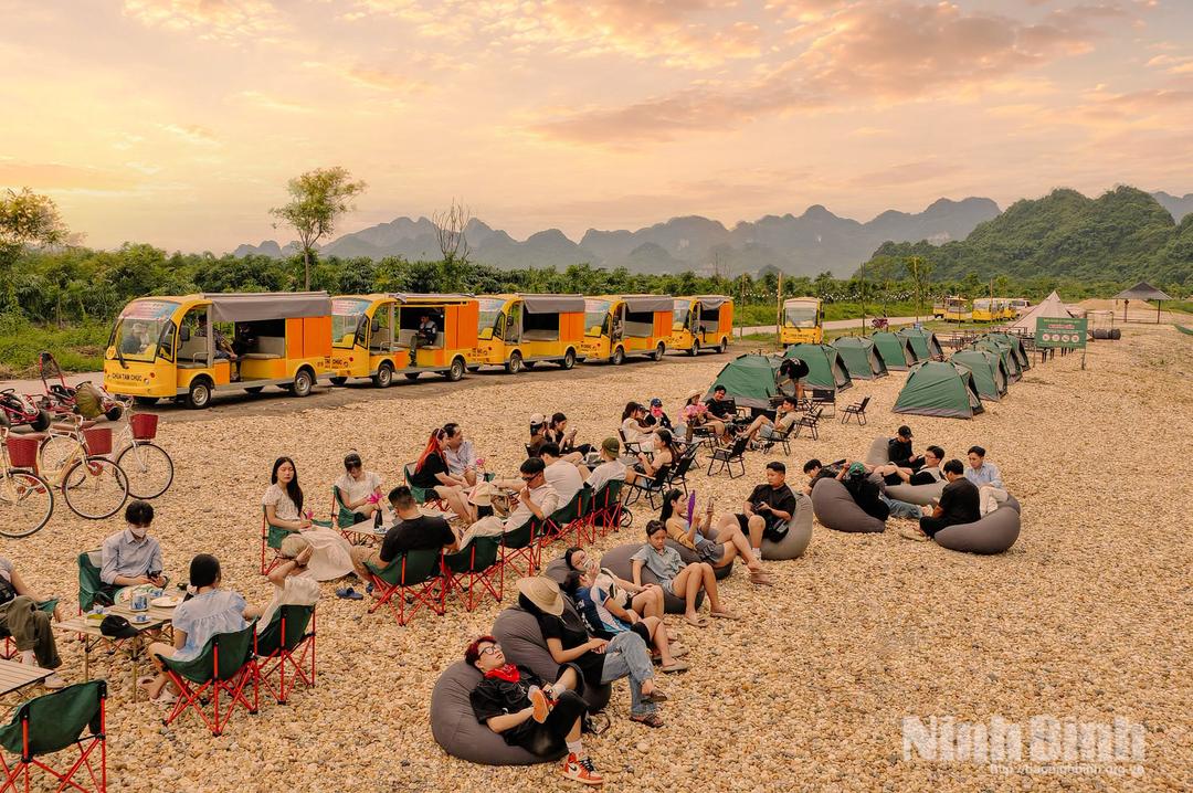 Những lều camping và xe lưu trú được bố trí bên bờ hồ, tạo nên không gian nghỉ dưỡng gần gũi với thiên nhiên.