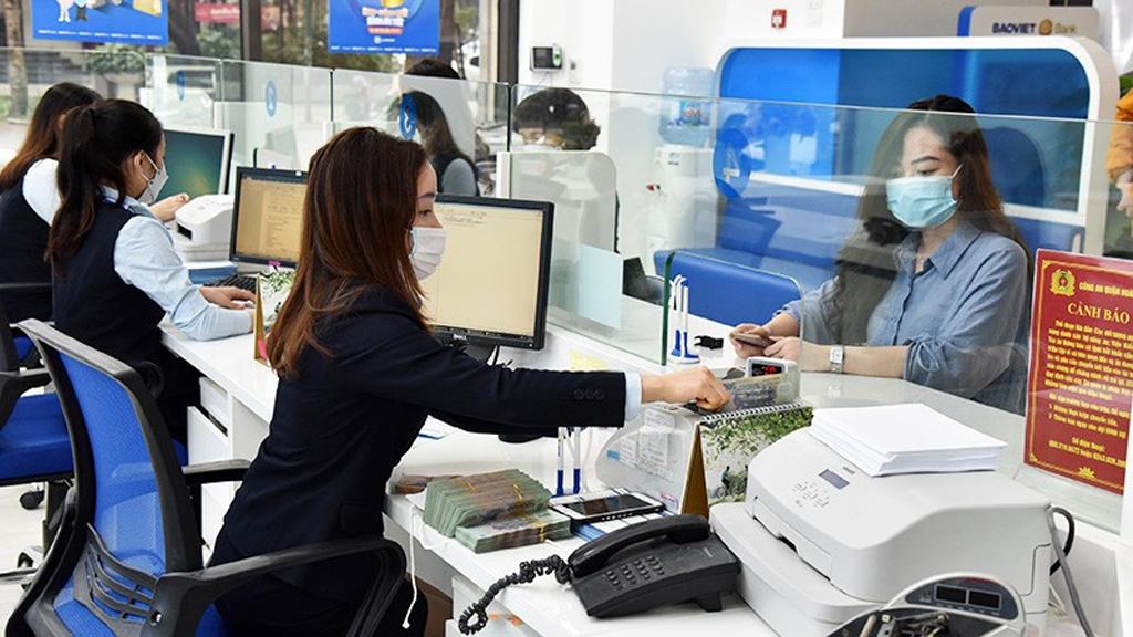 Khách hàng giao dịch tại Ngân hàng Bảo Việt (Hà Nội). (Ảnh: TRẦN HẢI)