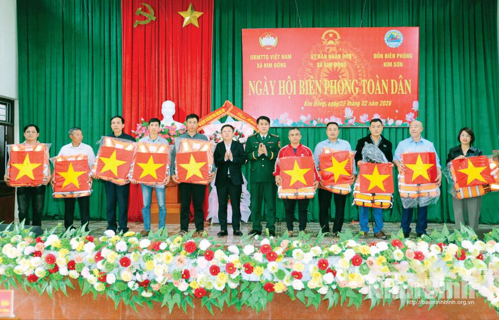 Lãnh đạo Ban Chỉ huy BĐBP tỉnh và xã Kim Đông trao tặng áo phao và cờ Tổ quốc cho ngư dân.