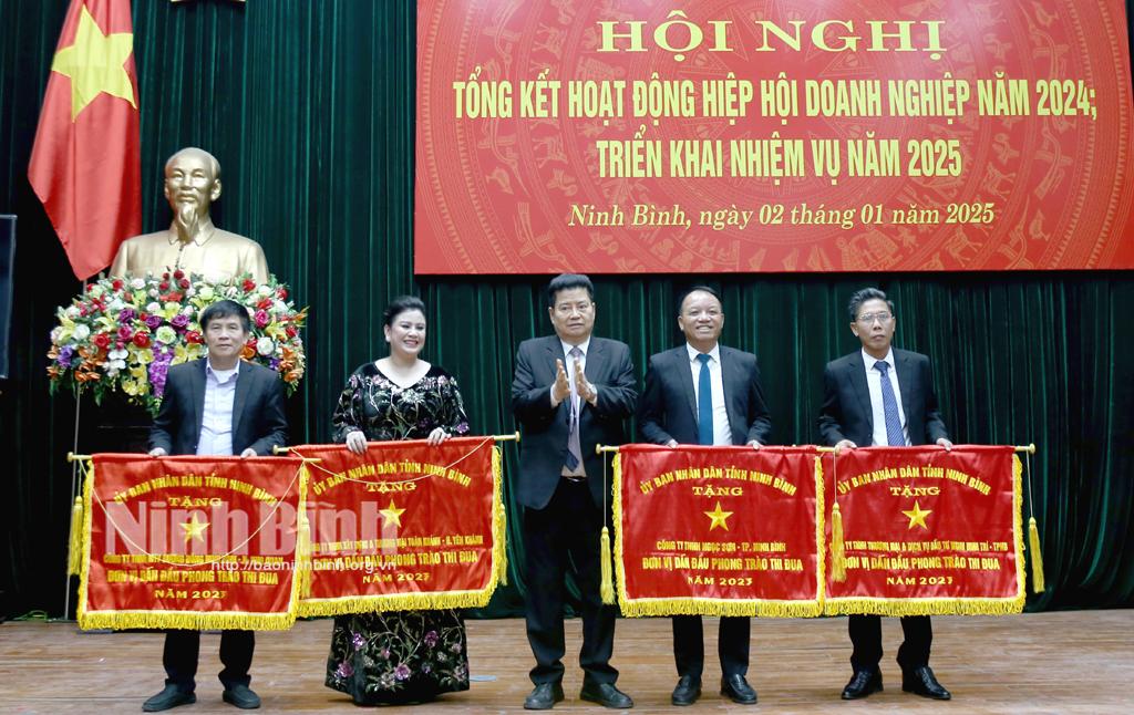 Ông Nguyễn Xuân Thành, Chủ tịch Hiệp hội Doanh nghiệp tỉnh trao Cờ thi đua của UBND tỉnh cho các đơn vị có thành tích trong năm 2024.