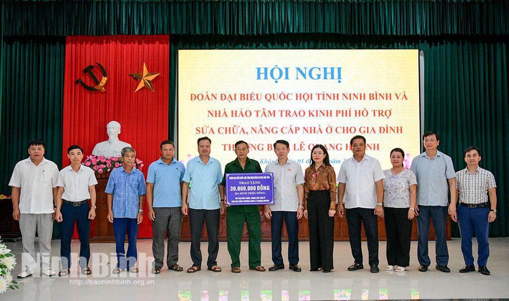 Đồng chí Nguyễn Hải Dũng, Tỉnh ủy viên, Phó trưởng Đoàn đại biểu Quốc hội tỉnh và nhà hảo tâm cùng các đại biểu trao kinh phí hỗ trợ cho gia đình thương binh Lê Quang Huynh.